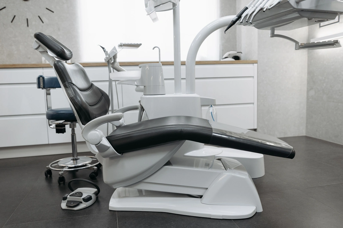 Modern dental office with a reclined dental chair and overhead equipment