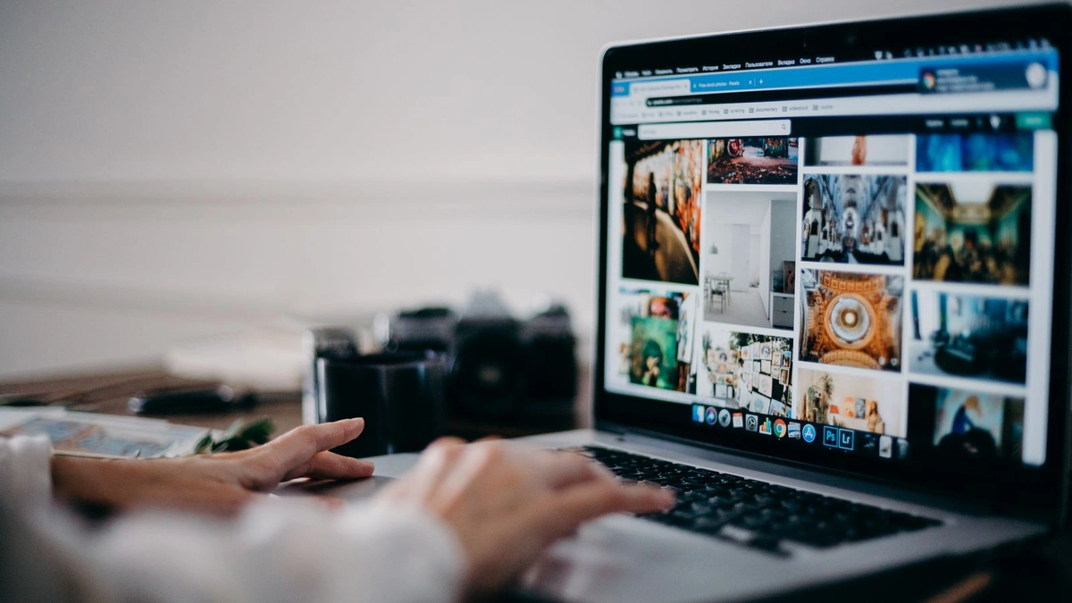 A person using a laptop to browse and search image results online