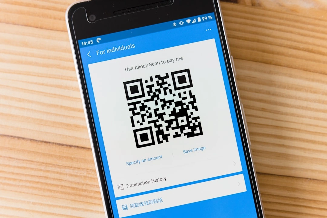 A mobile phone with a QR code displayed on it.