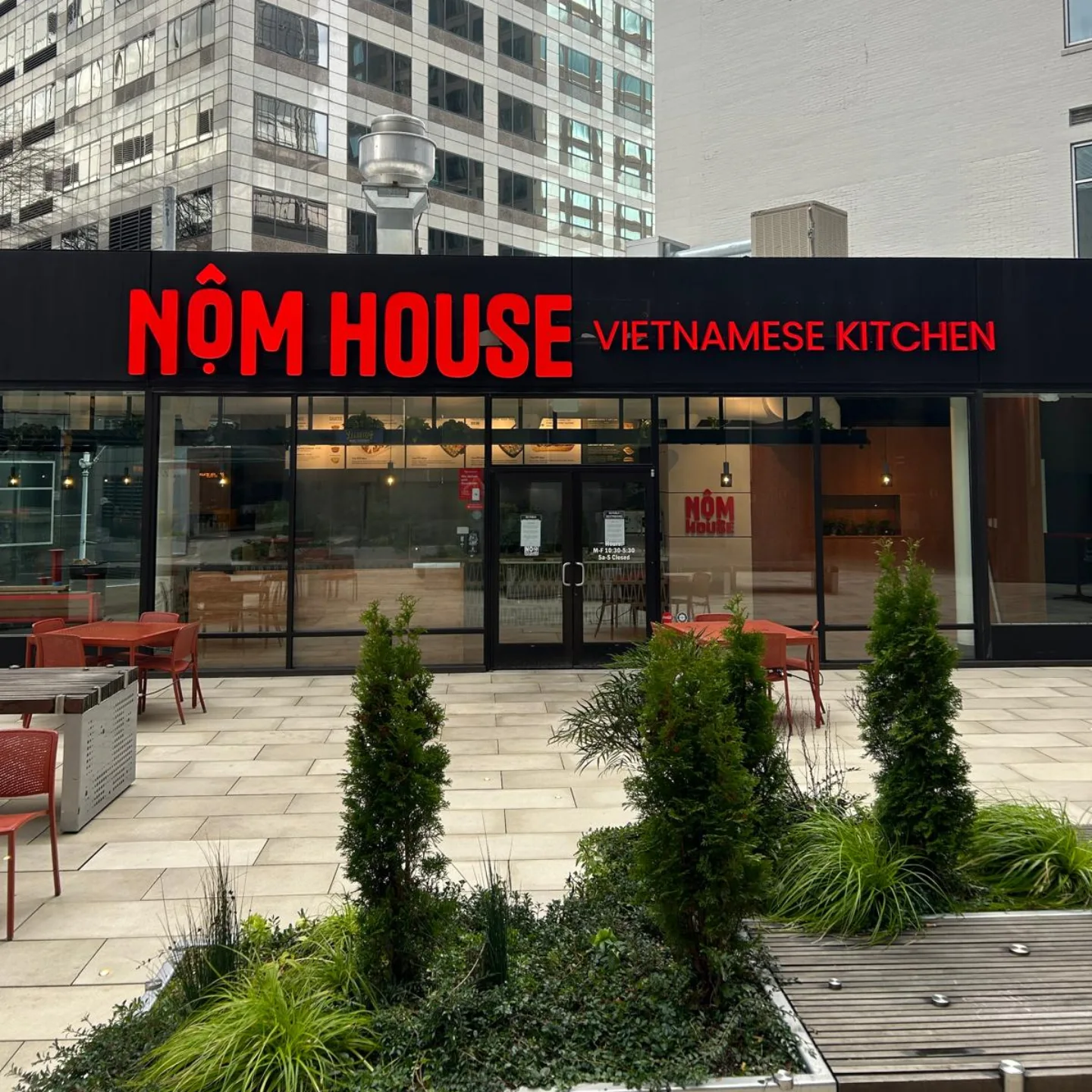 Nom House Vietnamese Kitchen restaurant exterior with illuminated signage