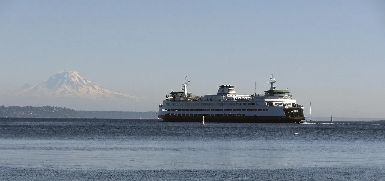 A Washington State ferry on Puget Sound with Mount Rainier behind it.