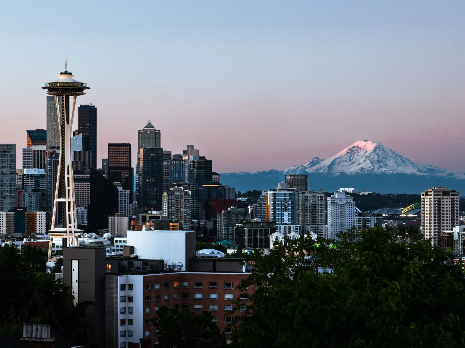 The Seattle skyline and the Space Needle with Mount Rainier at dawn.
