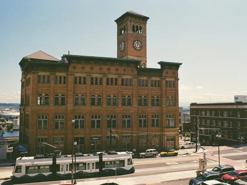 Tacoma's Old City Hall clock tower with the Tacoma Link streetcar passing.