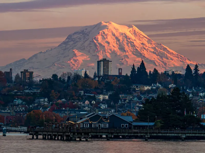 Mount Rainier glowing at dusk over Tacoma's waterfront.